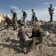 Syrian refugees Taima and her 3-year-old son, Wael, walk around the Acropolis in Athens. Image by Lynsey Addario. Greece, 2017.