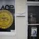 The Rev. Ezekiel Holley, 78, of Dawson, Ga., a leader of the NAACP, looks out from behind the office door window wearing a protective mask on Sunday, April 19, 2020, amid the COVID-19 coronavirus outbreak in Dawson, Ga. Image by Brynn Anderson / AP Photo. United States, 2020.