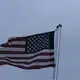 A tattered U.S. flag whips in a heavy wind on Sunday, April 19, 2020, in Dawson, Ga. Image by Brynn Anderson / AP Photo. United States, 2020.