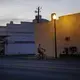 A man riding a bicycle down an empty street wears a protective mask amid the COVID-19 coronavirus outbreak on Friday, April 17, 2020, in Dawson, Ga. Image by Brynn Anderson / AP Photo. United States, 2020.