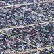 Administrators of the Royal Purple Raceway, in Baytown, Texas, have cancelled its fall schedule and turned the four-hundred-acre property into a temporary lot for about twenty-eight thousand storm-damaged vehicles that await salvage or disposal. Image by Alex MacLean. United States, 2017. 