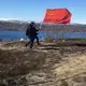 Two men carry a Soviet flag Murmansk, Russia. Image by Amy Martin. Russia, 2018.