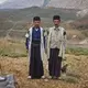 Ali Hasan Darvishi (left), 40, stands with a relative, Ali Ahmad Ghorbani, at the front of the Darvishi family’s tent. Darvishi fell in love with his wife in school. Image by Newsha Tavakolian. Iran, 2018.