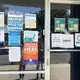 Signs direct community members to resources on MICOP's front window.