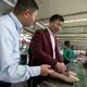 Zhang Huarong, chief executive of Huajian Shoe Co., inspects the production lines. Left, in the Chinese-owned Huajian Shoe Co. Factory in Addis Ababa, more than 6,000 workers build shoes for American brands such Tommy, Guess and Lucky. Image by Noah Fowler. Ethiopia, 2017.