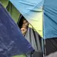 The camp near the Gateway International Bridge, which connects Matamoros and Brownsville, began forming last year. Media reports say Mexican officials plan to move the migrants to a stadium farther from the river. Image by Miguel Gutierrez Jr. Mexico, 2019.