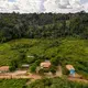 The home of Elias da Silva Lima and his family, center, and a school, left, are pictured in the Virola Jatoba settlement in Anapu. Image by Spenser Heaps. Brazil, 2019.