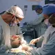 Surgeons Pedro Rivas (left) and Carlos Rodríguez (right) in the midst of a kidney transplant at the private hospital Clínica Metropolitana. Image by Flaviana Sandoval. Venezuela, 2018.