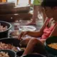 Peeling garlic sold to fast food restaurants has become a popular job in squatter areas like Isla Puting Bato. Image by Micah Castelo. Philippines, 2019