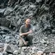 A worker on the road building team pauses in the rubble at McKenzie Inlet. Image by Joshua Cogan. United States, 2019.