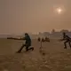 Surrounded by a thick layer of pollution that settled over Patna overnight, a dawn cricket match gets underway at Gandhi Maidan Park in central Patna. Image by Larry C. Price. India, 2018.