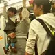A young woman carrying her son on the train in Shanghai. Image by Argentina Maria-Vanderhorst. China, 2018.
