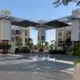 The main plaza of The Sustainable City is lined with apartments, shaded by a solar panel covering, and features a fountain which uses recycled grey water from the villas. Image by Anna Gleason. United Arab Emirates, 2019.