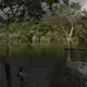 Sateré Mawé indigenous children play in the Tarumã Açu River River in the Gaviao community near Manaus, Brazil, Friday, May 29, 2020. The indigenous people of Manaus live together in poor neighborhoods where they struggle to maintain their native languages, culture, and identity on the fringes of Brazilian society. Image by Felipe Dana / AP Photo. Brazil, 2020.