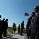 A flag flies half staff as dignitaries gather for a wreath-laying ceremony at the St. Christophe memorial just north of Port-au-Prince. Image by Allison Shelley. Haiti, 2019.