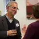 Justin Catanoso, journalism professor Wake Forest, chats with Ann Peters, university and community outreach director at the Pulitzer Center, during lunch on Friday, October 18. Image by Claire Seaton. United States, 2019.<br />
