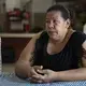 Anjelica Zavala sits at a table in the dining room at Casa Indi. According to Zavala, her parents, husband and cousins were murdered by gangs in El Salvador. Zavala has an asylum hearing scheduled for the fall. Aug. 6, 2019. Image by Miguel Gutierrez Jr. Mexico, 2019.