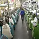 ASHEBORO, NORTH CAROLINA - Jordan Schindler, Founder and CEO of Nufabrx, walks through a row of machines producing Theramasks at the Bossong Medical plant in Asheboro, N.C. on Thursday, July 16, 2020. Image by Jeff Siner/The Charlotte Observer/North Carolina News Collaborative. United States, 2020.