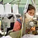 ASHEBORO, NORTH CAROLINA - Francisca Romero sews a product at the Bossong Medical plant in Asheboro, NC on Thursday, July 16, 2020. The Bossong Medical plant in Asheboro contracted to make Nufabrx items. The company is churning out hundreds of thousands of masks, including one order of 250,000 masks to the federal government. Image by Jeff Siner/The Charlotte Observer/North Carolina News Collaborative. United States, 2020.