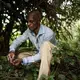 Bienvenue Efete, a healer, collects a herb he uses in his traditional remedy for snakebites. Image by Hugh Kinsella Cunningham. Congo, 2019.