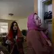 Zahra Ahmad, 24, watches as her mother, Lamiya Adil Mahdi, demonstrates how to wrap a hijab in her home in Lansing, Michigan on Friday, Feb. 1, 2019, hours before she departs for Iraq. Image by Brontë Wittpenn. United States, 2019.