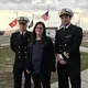 Pentagon paid attorney Susan Hensler, center, is the lead defense counsel for the former CIA captive charged as Abd al Hadi al Iraqi. At left is Navy Lieutenant Charles D. Ball III and at right is Navy Lieutenant Dahoud A. Askar, both detailed defense attorneys in the al-Qaida commander case. They pose at the Camp Justice sign at the U.S. Navy base at Guantánamo Bay, Cuba, in this image approved for release by a U.S. military officer. Image courtesy of Carol Rosenberg.