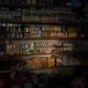 Light shines on goods in a convenience store in Sanaa. Image by Alex Potter. Yemen, 2018. 