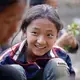 Twelve-year-old Wang Bing talks to a relative at her paternal grandparents' house during Torch Festival celebrations in Liangshan prefecture, Sichuan province. Image by Max Duncan. China, 2016.