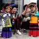 Yi children put on traditional dress during Torch Festival celebrations in Liangshan prefecture, Sichuan province. Image by Max Duncan. China, 2016.