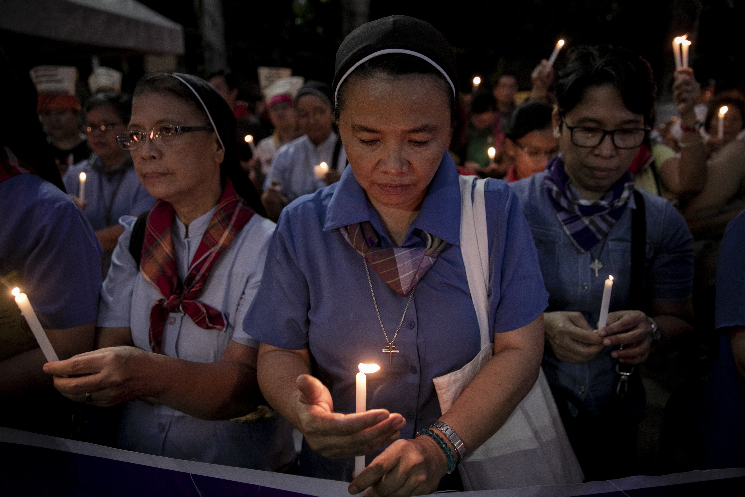 Nuns light their candles during a demonstration calling for "truth, justice, and peace" across Malate Church in Manila. Image by Eloisa Lopez. Philippines, 2019. Nuns light their candles during a demonstration calling for "truth, justice, and peace" across Malate Church in Manila. Image by Eloisa Lopez. Philippines, 2019.